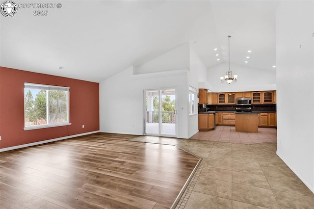 121 Mourning Dove Dr, Canon City, CO 81212 - unfurnished living room featuring a chandelier, healthy amount of natural light, high vaulted ceiling, recessed lighting, and light wood-style flooring