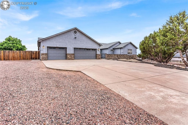 121 Mourning Dove Dr, Canon City, CO 81212 - view of front of house featuring stucco siding, stone siding, driveway, and a garage