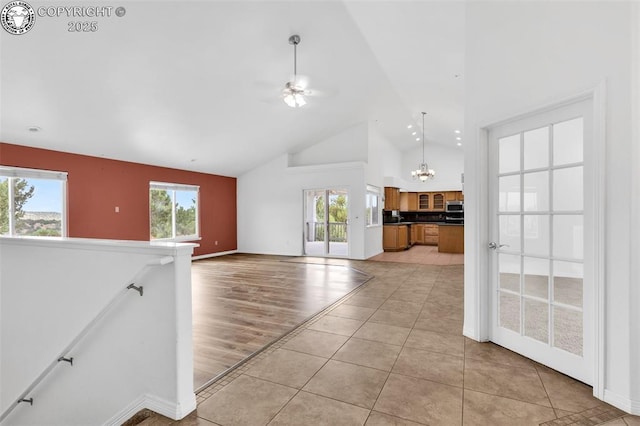 121 Mourning Dove Dr, Canon City, CO 81212 - unfurnished living room featuring high vaulted ceiling, a chandelier, healthy amount of natural light, and light tile patterned floors