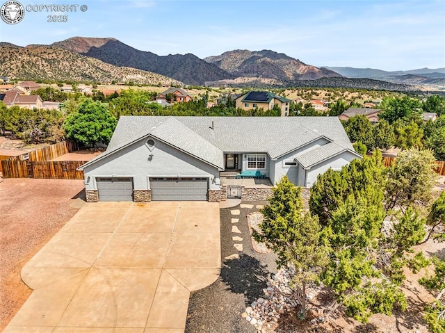 121 Mourning Dove Dr, Canon City, CO 81212 - single story home with concrete driveway, a garage, stucco siding, a mountain view, and stone siding