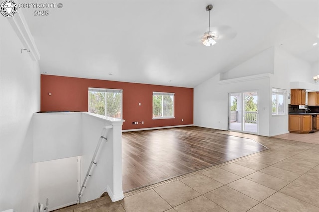 121 Mourning Dove Dr, Canon City, CO 81212 - unfurnished living room featuring light tile patterned floors and high vaulted ceiling