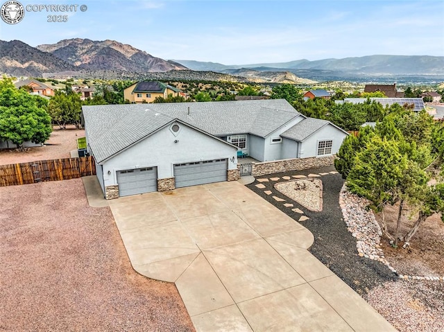 121 Mourning Dove Dr, Canon City, CO 81212 - ranch-style house with a garage, stucco siding, driveway, a mountain view, and stone siding
