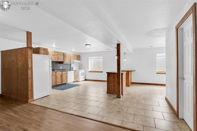 121 Mourning Dove Dr, Canon City, CO 81212 - kitchen featuring white appliances, decorative backsplash, healthy amount of natural light, open floor plan, and recessed lighting