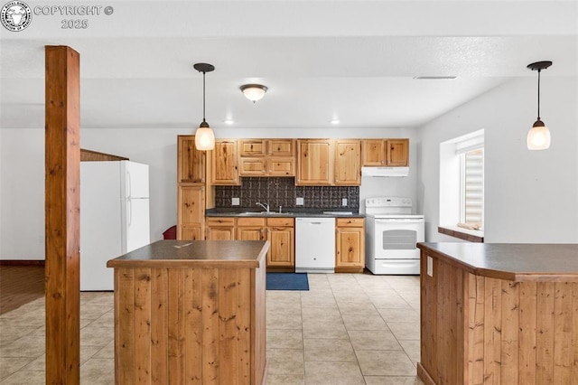 121 Mourning Dove Dr, Canon City, CO 81212 - kitchen featuring white appliances, dark countertops, light tile patterned floors, and under cabinet range hood