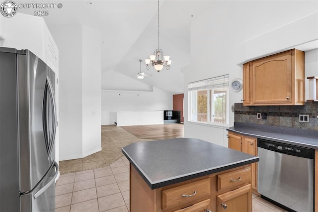 121 Mourning Dove Dr, Canon City, CO 81212 - kitchen featuring appliances with stainless steel finishes, dark countertops, a chandelier, lofted ceiling, and light tile patterned floors