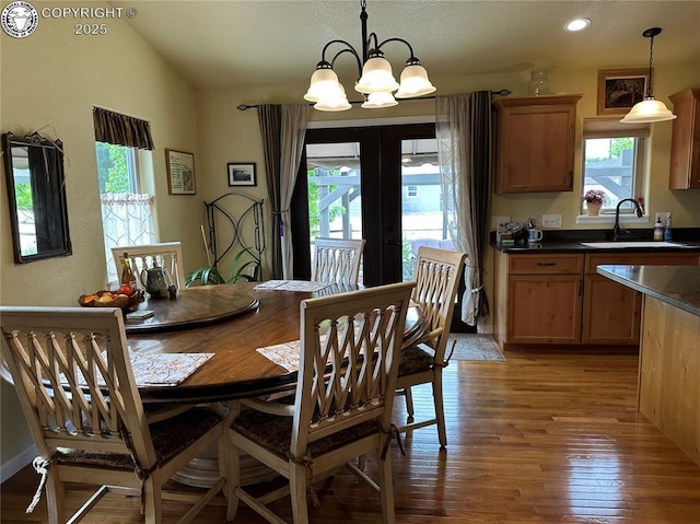 601 Petroleum Ave, Florence, CO 81226 - dining area with healthy amount of natural light, light wood-style flooring, a chandelier, french doors, and lofted ceiling