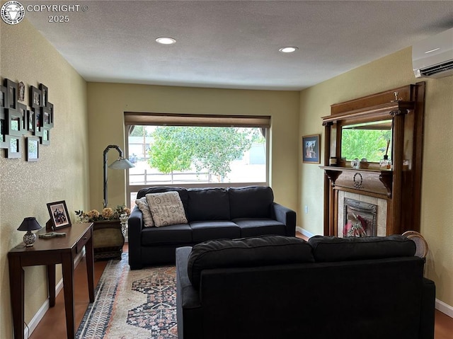 601 Petroleum Ave, Florence, CO 81226 - living room featuring a wall mounted AC, baseboards, recessed lighting, and a textured wall