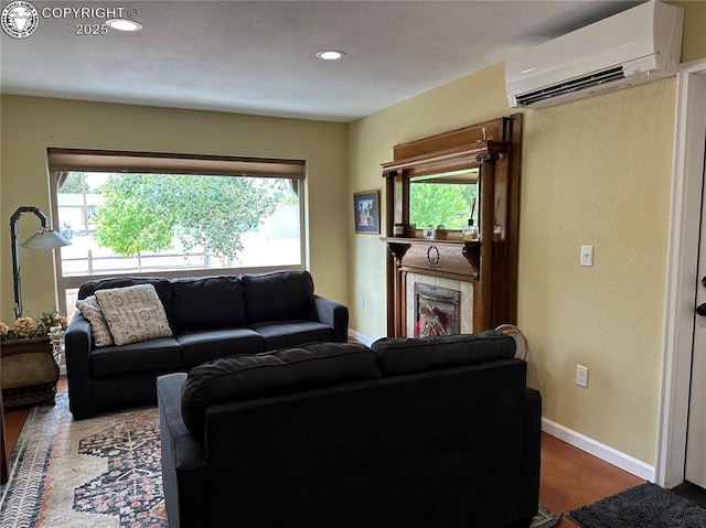 601 Petroleum Ave, Florence, CO 81226 - living area with an AC wall unit, plenty of natural light, baseboards, recessed lighting, and a textured wall