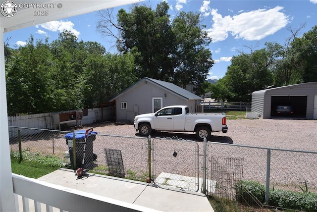 221 Greydene Ave, Canon City, CO 81212 - view of side of home featuring an outbuilding, a detached garage, and driveway