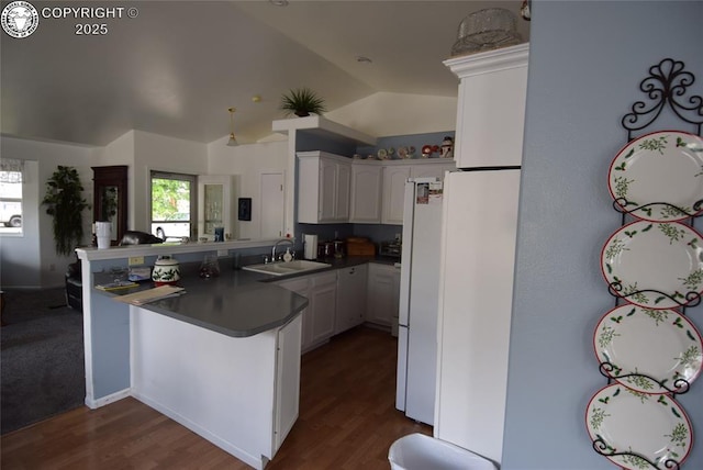 221 Greydene Ave, Canon City, CO 81212 - kitchen featuring a peninsula, dark countertops, white cabinetry, lofted ceiling, and healthy amount of natural light