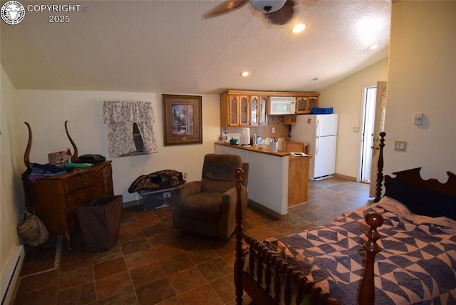 221 Greydene Ave, Canon City, CO 81212 - bedroom with freestanding refrigerator, baseboard heating, vaulted ceiling, and recessed lighting