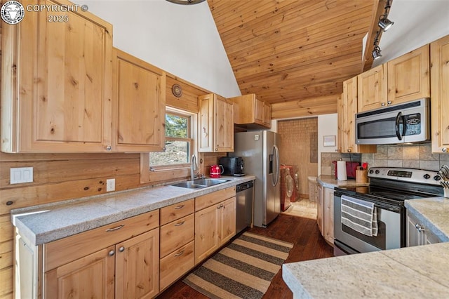 kitchen featuring light brown cabinetry, a sink, vaulted ceiling, wooden ceiling, and appliances with stainless steel finishes