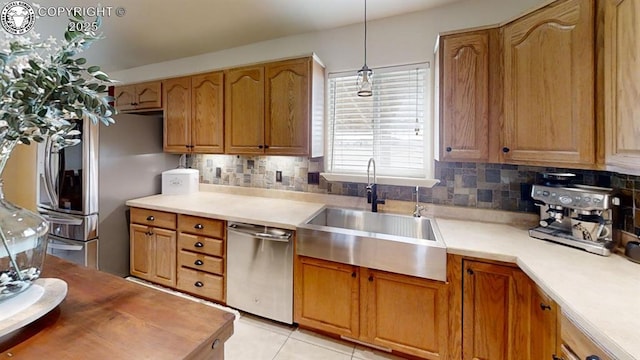 1018 S Camino De Bravo, Pueblo West, CO 81007 - kitchen with appliances with stainless steel finishes, a sink, decorative backsplash, and light countertops