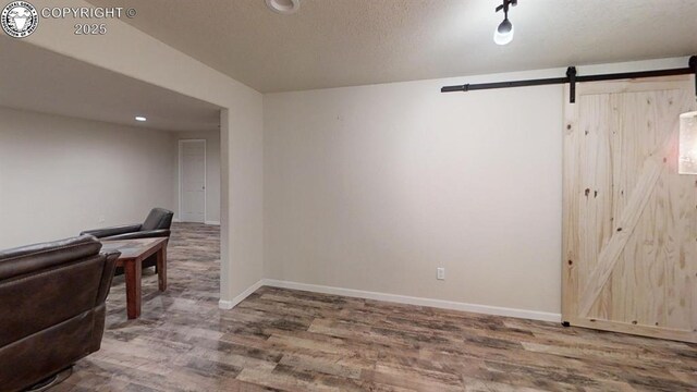 1018 S Camino De Bravo, Pueblo West, CO 81007 - interior space with a barn door, wood finished floors, baseboards, and recessed lighting