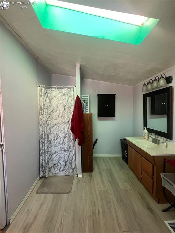 bathroom featuring vanity, hardwood / wood-style floors, and curtained shower