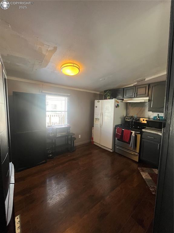 kitchen featuring stainless steel range, dark wood-type flooring, ornamental molding, and white fridge with ice dispenser