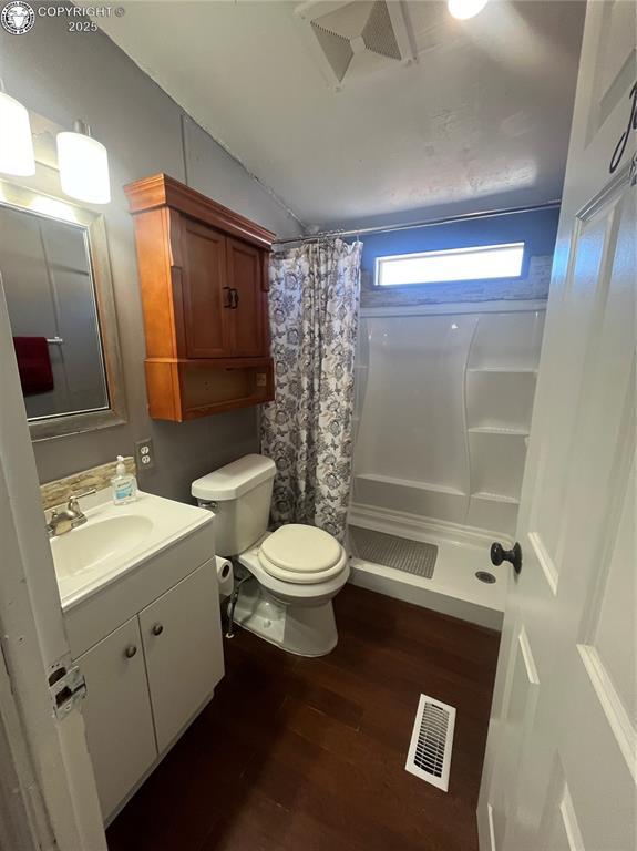 bathroom featuring a shower with curtain, vanity, toilet, and hardwood / wood-style floors