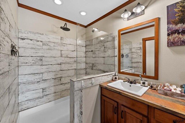 bathroom with vanity and a tile shower