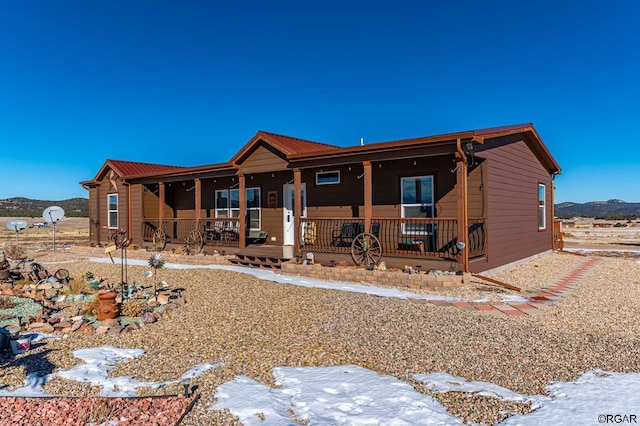 view of front of house featuring a mountain view and covered porch