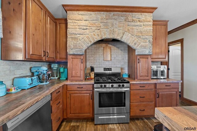 kitchen featuring gas range, ornamental molding, wooden counters, and dishwasher