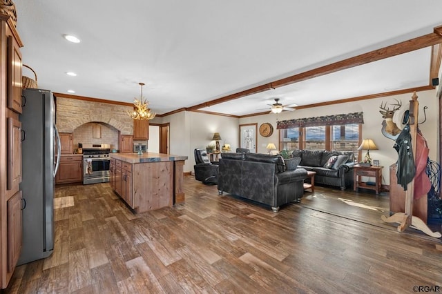 kitchen with crown molding, dark hardwood / wood-style floors, stainless steel appliances, and a center island