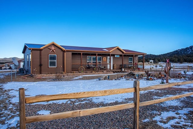 view of front of home featuring a mountain view and covered porch