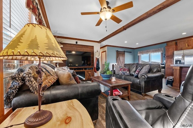 living room with ceiling fan, ornamental molding, and light hardwood / wood-style flooring