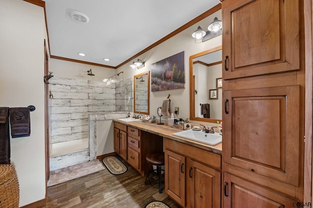 bathroom featuring ornamental molding, tiled shower, hardwood / wood-style floors, and vanity