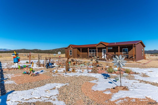 exterior space with a porch and a mountain view