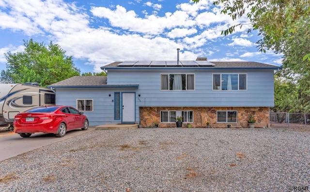 view of front of property featuring solar panels