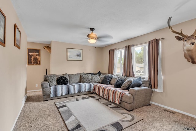 living room with ceiling fan and light colored carpet