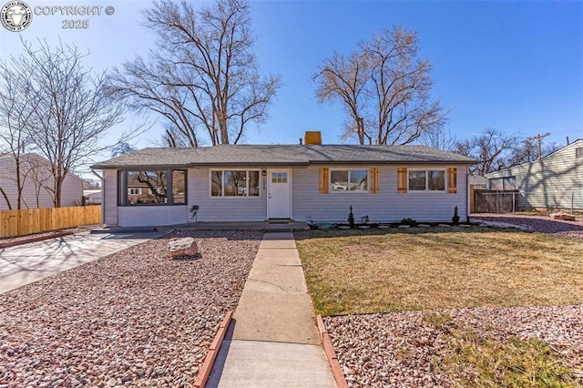 single story home with a chimney, a front lawn, and fence