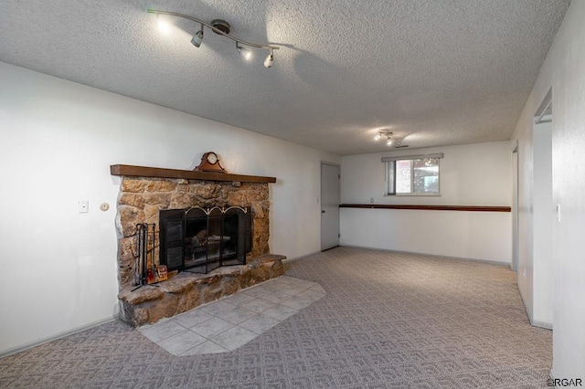 unfurnished living room with a stone fireplace, light colored carpet, and a textured ceiling