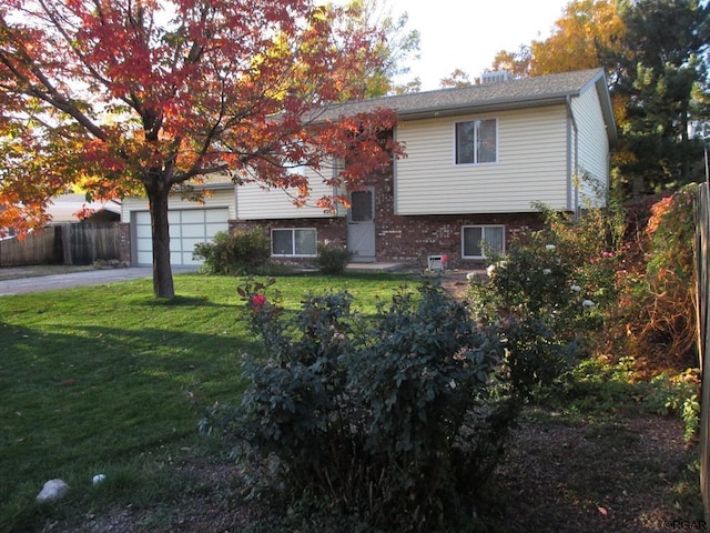 420 6th Ter, Florence, CO 81226 - back of property with brick siding, fence, aphalt driveway, a garage, and a yard