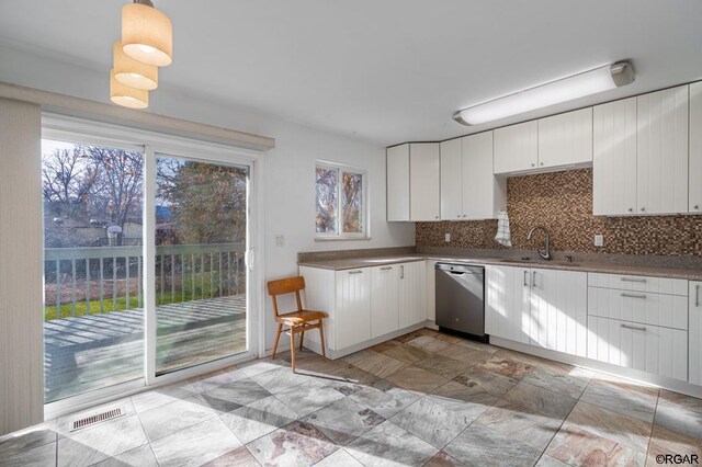 kitchen featuring white cabinetry, sink, decorative backsplash, and appliances with stainless steel finishes