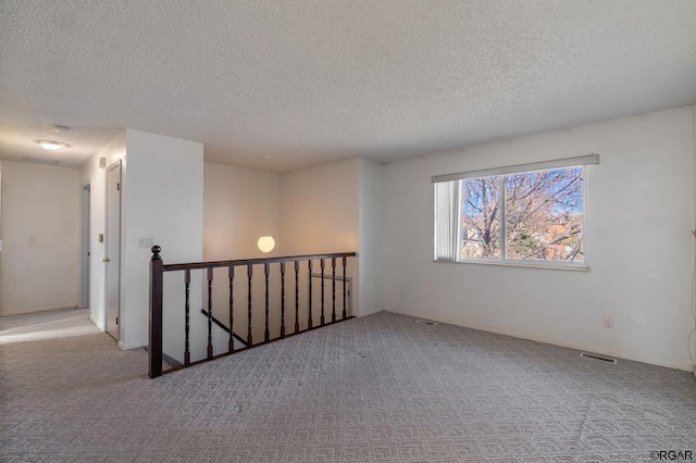 420 6th Ter, Florence, CO 81226 - carpeted empty room featuring baseboards, visible vents, and a textured ceiling