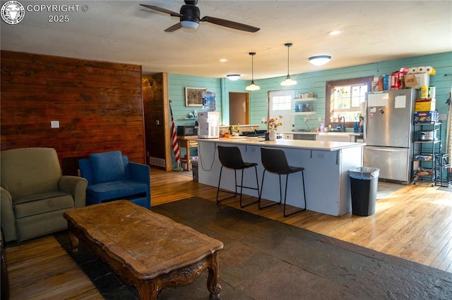 430 Broadway St, Silver Cliff, CO 81252 - kitchen with appliances with stainless steel finishes, wooden walls, ceiling fan, light countertops, and decorative light fixtures