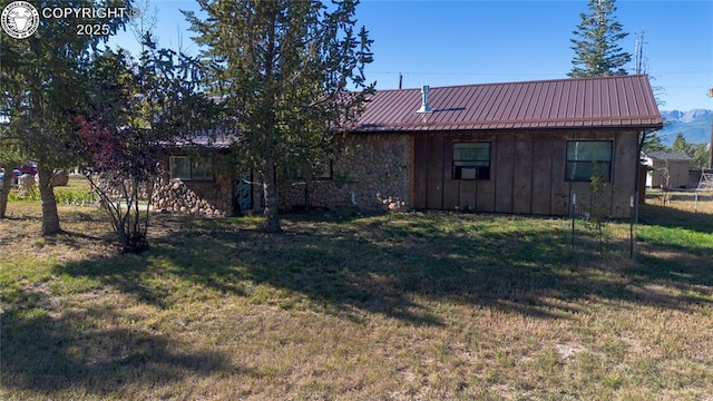 430 Broadway St, Silver Cliff, CO 81252 - back of house featuring board and batten siding, a yard, a metal roof, and stone siding
