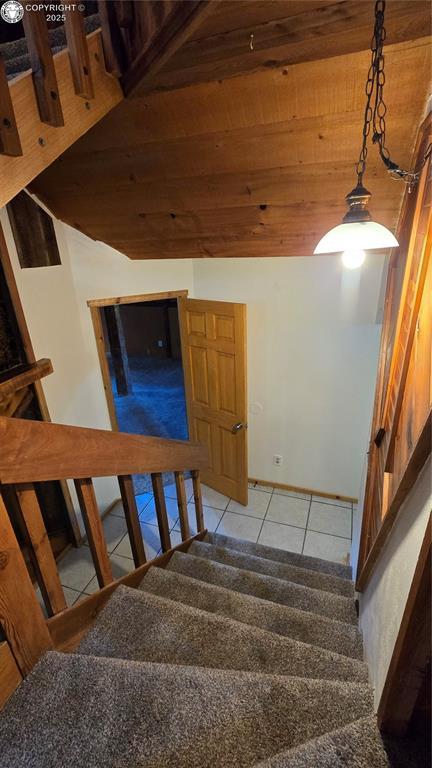 21501 Chalk Creek Dr, Nathrop, CO 81236 - stairway with tile patterned floors, wood ceiling, vaulted ceiling, and visible vents