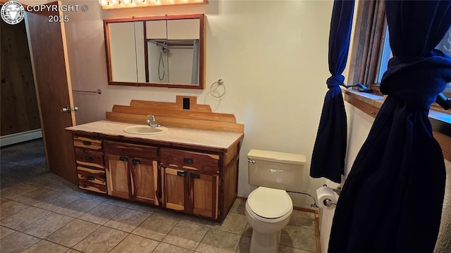 21501 Chalk Creek Dr, Nathrop, CO 81236 - full bath featuring a baseboard radiator, toilet, tile patterned flooring, and vanity