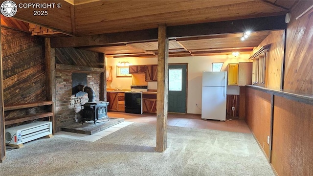 21501 Chalk Creek Dr, Nathrop, CO 81236 - unfurnished living room featuring wooden ceiling, a sink, wood walls, a wood stove, and light colored carpet