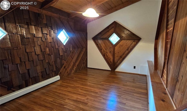 21501 Chalk Creek Dr, Nathrop, CO 81236 - additional living space with wooden ceiling, wood walls, wood finished floors, and a baseboard heating unit