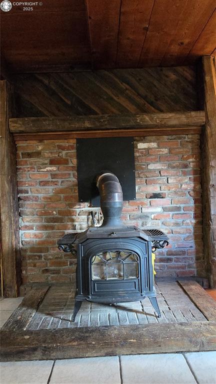 21501 Chalk Creek Dr, Nathrop, CO 81236 - interior details with a wood stove, wooden walls, and wood ceiling