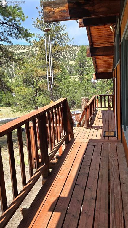 21501 Chalk Creek Dr, Nathrop, CO 81236 - wooden terrace featuring a view of trees