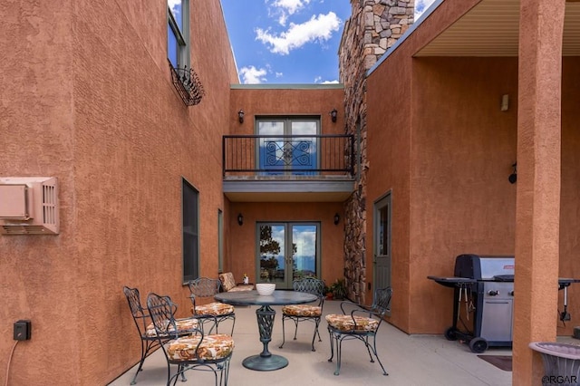 view of patio with a balcony and a grill