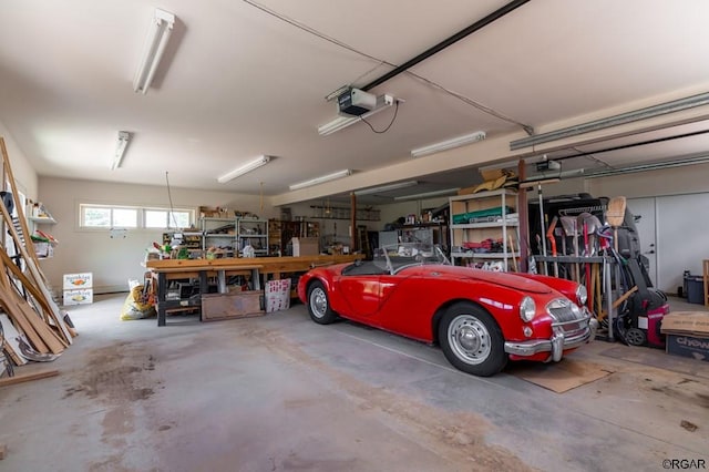 garage featuring a garage door opener and a workshop area