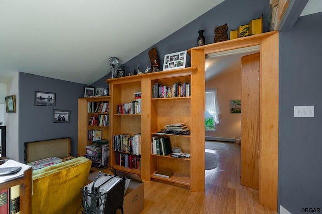 home office with vaulted ceiling and light hardwood / wood-style floors