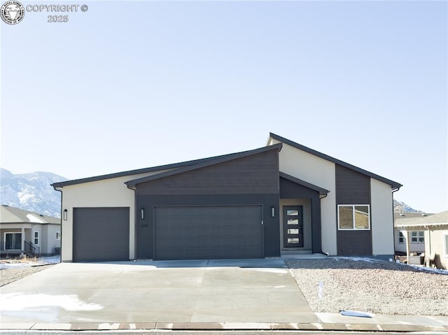 view of front of house with a garage and a mountain view