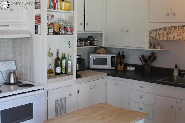 kitchen with white appliances, exhaust hood, white cabinetry, decorative backsplash, and open shelves