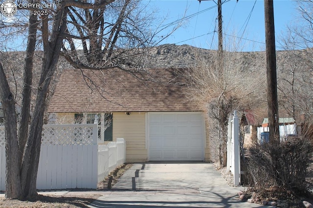 exterior space with concrete driveway and fence